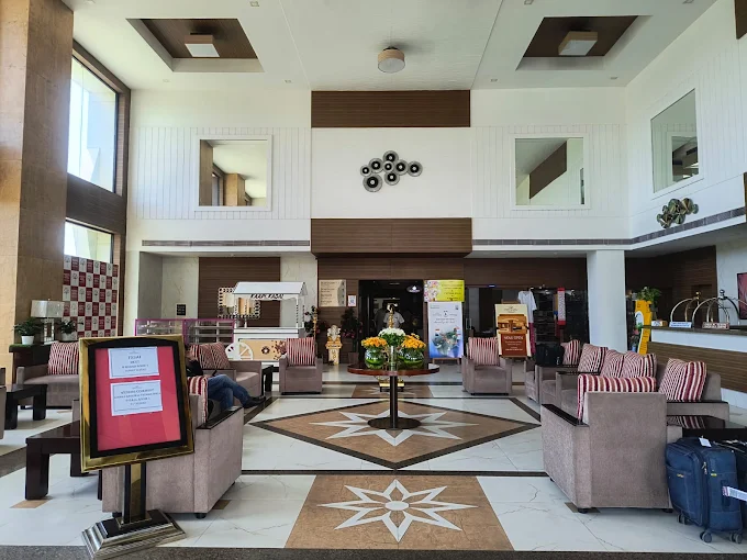 Spacious family room with balcony view at POPPYS Hotel Madurai