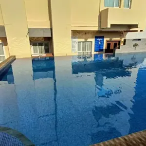 Swimming pool and Melting Pot restaurant at Poppys Hotel Madurai