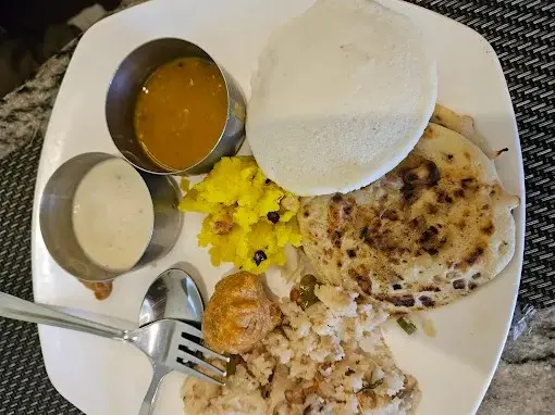 Neat and well-maintained hotel room with modern amenities in Ooty