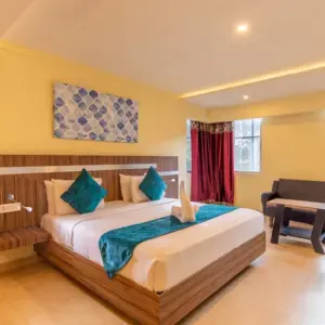 Clean hotel room interior at Vinayaga Inn by Poppys Ooty